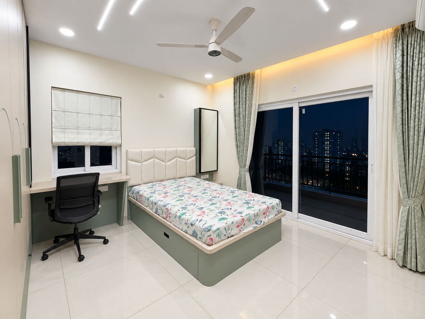 Bedroom with a study desk, upholstered bed and sage-green wardrobe base